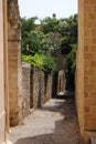 Vertical shot of a narrow street in Old Rhodes town Royalty Free Stock Photo