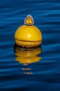Vertical shot of a nautical buoy floating in the water of Lake Geneva in Switzerland