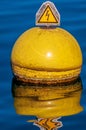 Vertical shot of a nautical buoy floating in the water of Lake Geneva in Switzerland Royalty Free Stock Photo