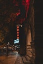 Vertical shot of Neon lights of Odeon Theatre illuminated the street of Victoria, British Columbia
