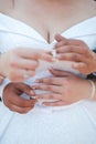 Vertical shot of a newly married couple embracing and putting rings on their fingers