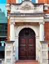 Vertical shot of Newnes public library entrance with wooden arch door Royalty Free Stock Photo
