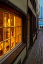 Vertical shot of a nicely-illuminated window in old Town Cologne, Germany