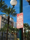 Vertical shot of a no-parking sign on a pole on Canal Street in New Orleans. French Quarter, USA. Royalty Free Stock Photo