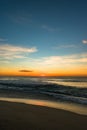 Vertical shot of the North Entrance Beach under a blue sky at sunrise