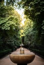 Vertical shot of a not-working fountain in the middle of a park path