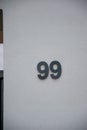 Vertical shot of the number 99 on a door