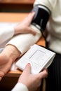 vertical shot of a nurse& x27;s hand checking a patient& x27;s blood pressure in a hospital room. Royalty Free Stock Photo