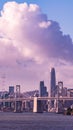 Vertical shot of the Oakland Bay Bridge with skyscrapers in the background with purple cloudy sky Royalty Free Stock Photo