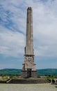 Vertical shot of Obeliscul lui Horea, Closca si Crisan tower against the sky. Alba Iulia, Romania.