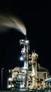 Vertical shot of an oil refinery with light at night