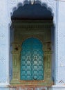 Vertical shot of an old blue door in Indian-style decorations Royalty Free Stock Photo