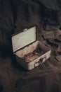 Vertical shot of an old box with a silver key and rusty nuts and bolts Royalty Free Stock Photo