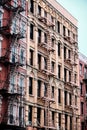 Vertical shot of an old brick building facade in Manhattan New York City during daytime Royalty Free Stock Photo