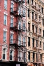 Vertical shot of an old brick building facade in Manhattan New York City during daytime Royalty Free Stock Photo