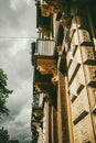 Vertical shot of an old building facade with columns, balconies, and carved details Royalty Free Stock Photo