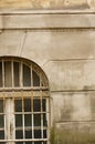 Vertical shot of an old building with metal railing for the window Royalty Free Stock Photo