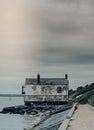 Vertical shot of an old coastguard watchhouse under a cloudy sky at Lepe Beach, Hampshire, UK.