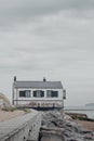 Vertical shot of an old coastguard watchhouse under a cloudy sky at Lepe Beach, Hampshire, UK.