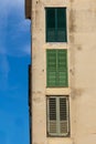 Vertical shot of an old concrete building with weathered windows with interesting textures