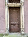 Vertical shot of an old door of an abandoned build