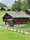 Vertical shot of old farmhouses in Zillertaler, Alps