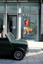 Vertical shot of an old green Mini Cooper parking in front of a shop in city Hamburg