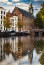 Vertical shot of an Old Historical University with water reflection in autumn, Leiden, Netherlands
