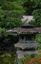Vertical shot of an old Japanese lantern in a park Royalty Free Stock Photo