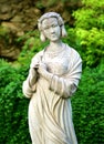 Vertical shot of an old marble Chinese lady statue in a park under the sunlight