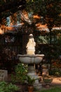 Vertical shot of an old marble fountain at the city park on a sunny day Royalty Free Stock Photo