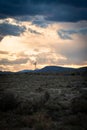 Vertical shot of an old metal farm windmill against scenic sunset in South Africa Royalty Free Stock Photo