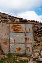 Vertical shot of an old metal rusty and abandoned farm door Royalty Free Stock Photo