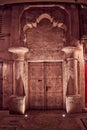 Vertical shot of old ornamental wooden door of an Arabic market,  illuminated by lamps at night Royalty Free Stock Photo