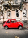 Vertical shot of an old red Fiat 500 parked on the street Royalty Free Stock Photo