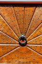 Vertical shot of an old round door knocker on a brown door Royalty Free Stock Photo