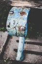 Vertical shot of on old rusty detail of a park bench