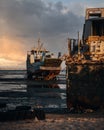 Vertical shot of an old ship at the shore at a beautiful soft sunset