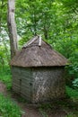 Vertical shot of an old small wooden hut in the middle of a forest Royalty Free Stock Photo