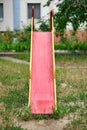 Vertical shot of an old soviet era red metal slide on a playground Royalty Free Stock Photo