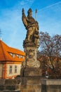 Vertical shot of an old stone statue of a bishop in Prague, Czech Republic