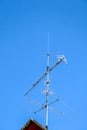 Vertical shot of an old style TV antenna under the blue sky