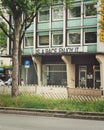 Vertical shot of an old traditional building with a Is a race enjoy it banner in Bochum, Germany