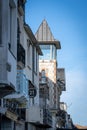 Vertical shot of old traditional buildings in Pornic front of the sea under blue sky