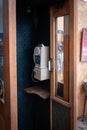 A vertical shot of an old vintage telephone on the wall