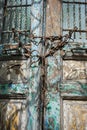 Vertical shot of an old weathered door locked with rusted chains Royalty Free Stock Photo