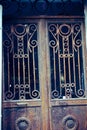 Vertical shot of an old weathered iron door with decorative elements Royalty Free Stock Photo