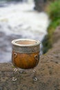 Vertical shot of an old wooden cup with metallic