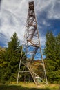 Vertical shot of the Olson Tower surrounded by greenery under a cloudy sky in West Virginia