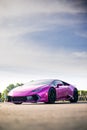 Vertical shot of a one of one Lamborghini Huracan with a carbon fiber body kit in a pink color